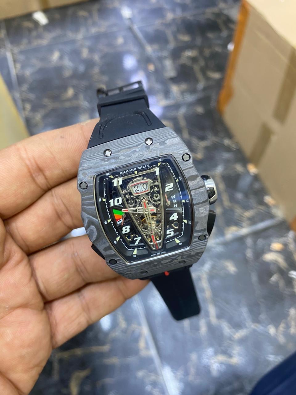 RM 40-01 McLaren — held in hand, angled view showing the case and black strap