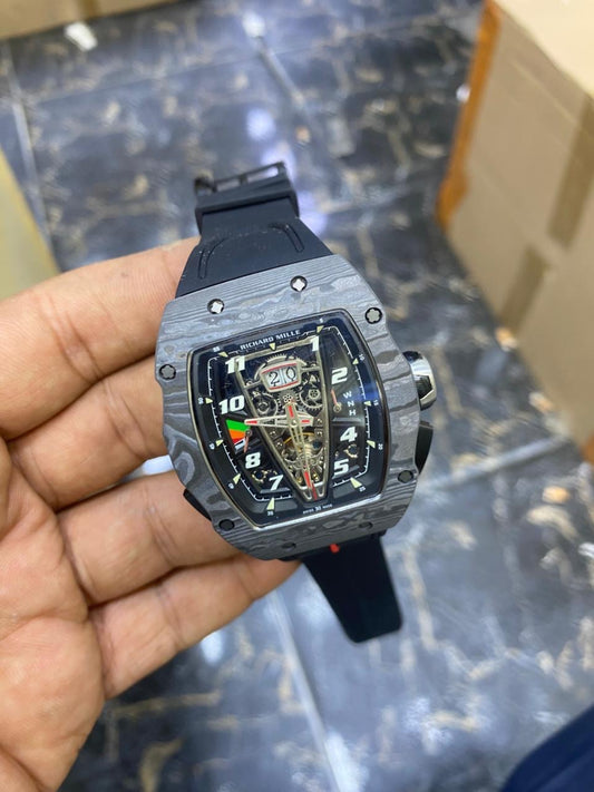RM 40-01 McLaren — held in hand, angled view showing the case and black strap