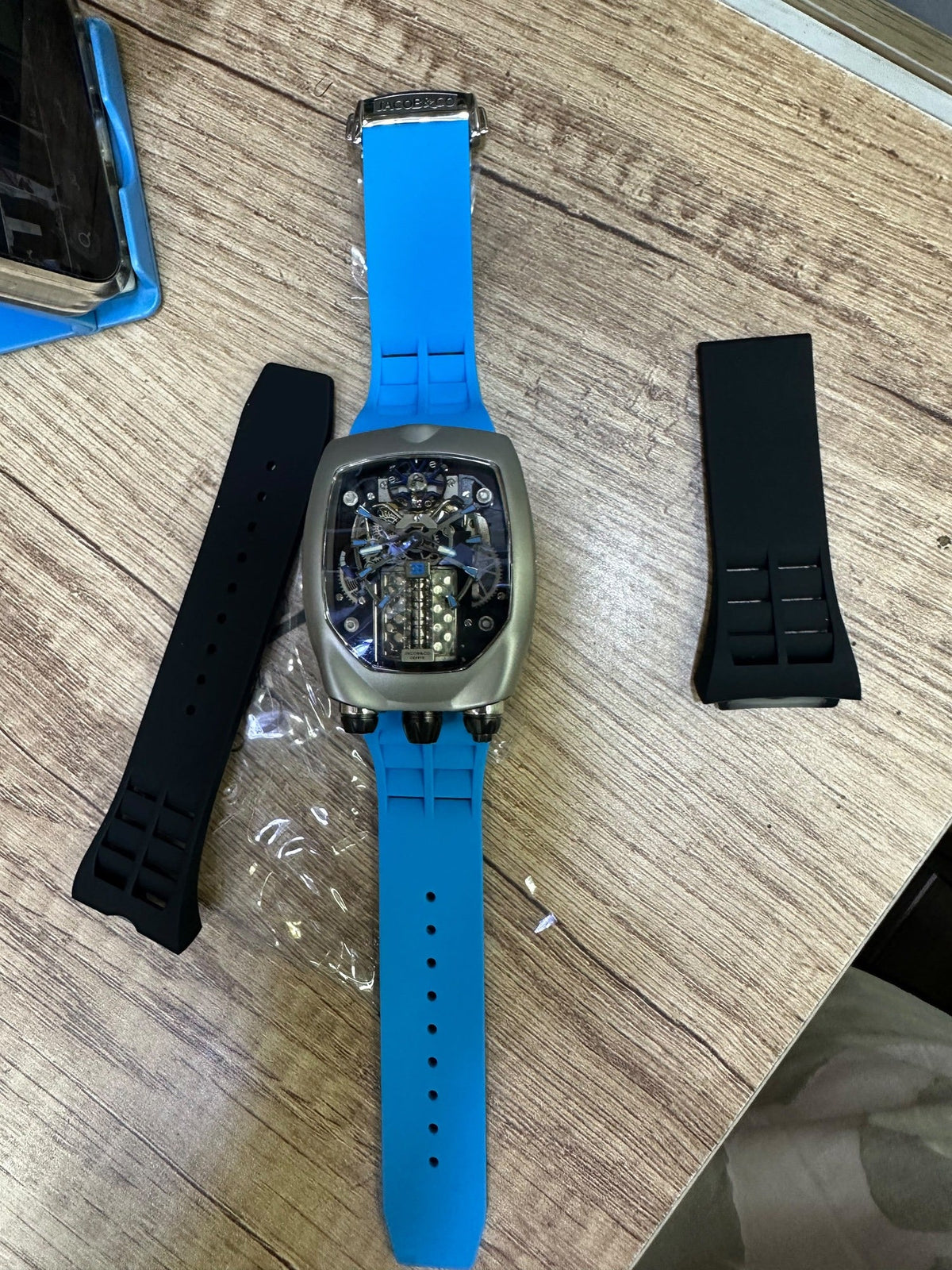 Bugatti Chiron Tourbillon laid flat with spare straps and the branded folding clasp