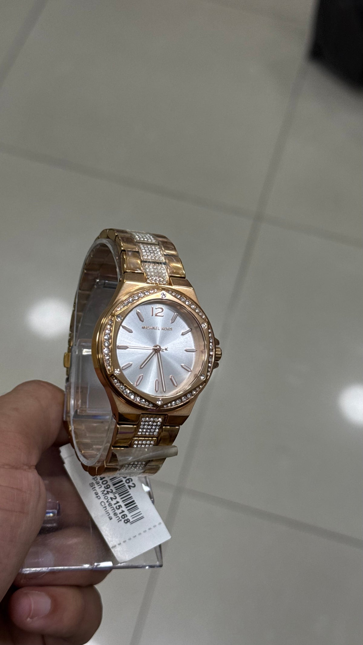 Michael Kors Lennox - angled view showing the faceted case and white sunray dial