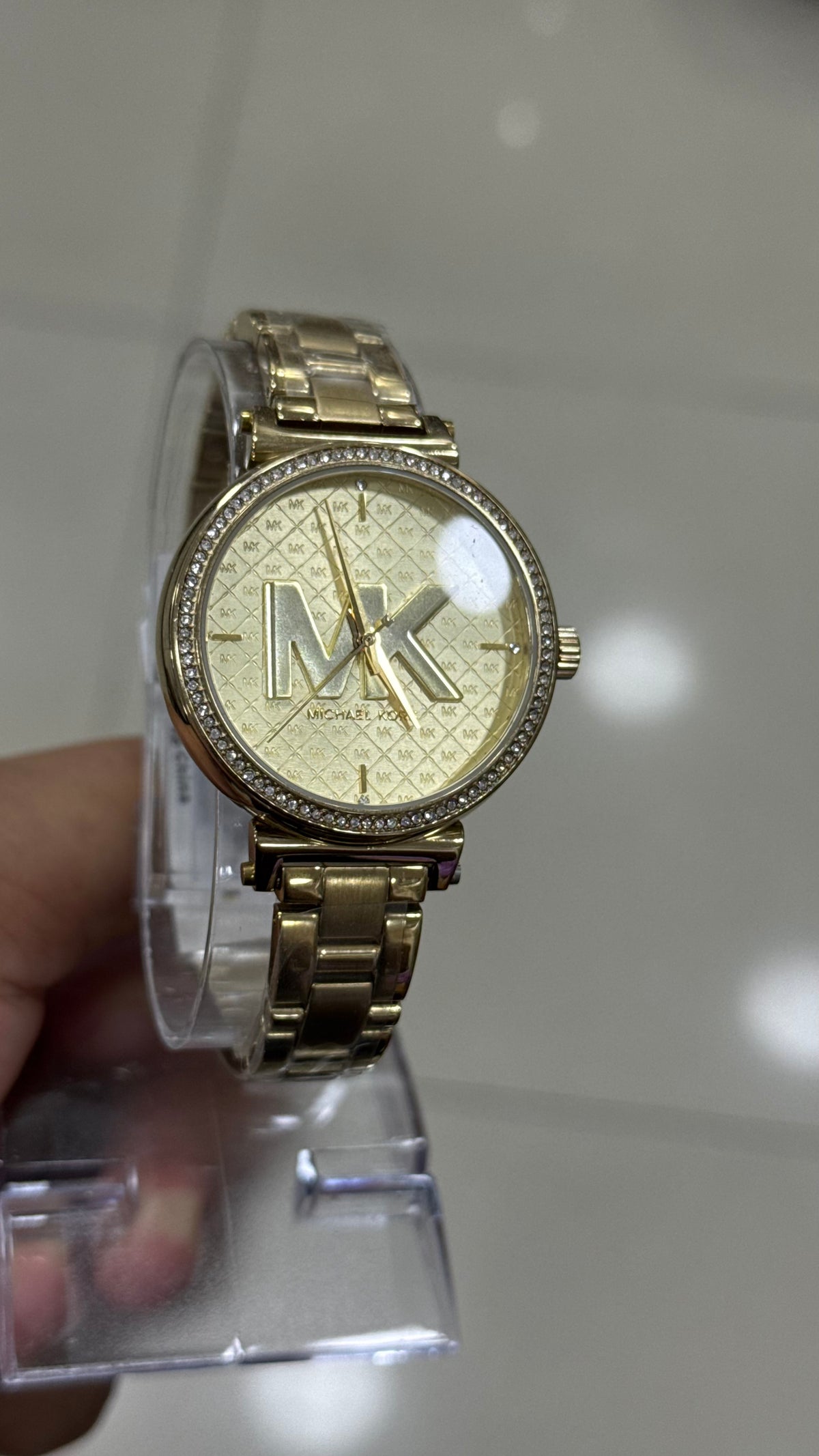 Michael Kors Sofie MK4334 in hand - crystal bezel and gold monogram dial